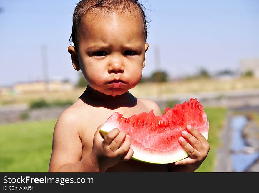 Little boy eating watermelon