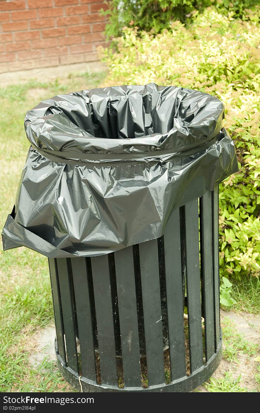 Black garbage bin with plastic liner