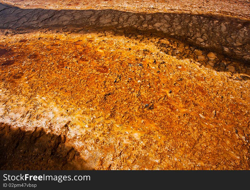 The microbial mat at Yellowstone's Midway Geyser Basin creates a colorful abstract. The microbial mat at Yellowstone's Midway Geyser Basin creates a colorful abstract.