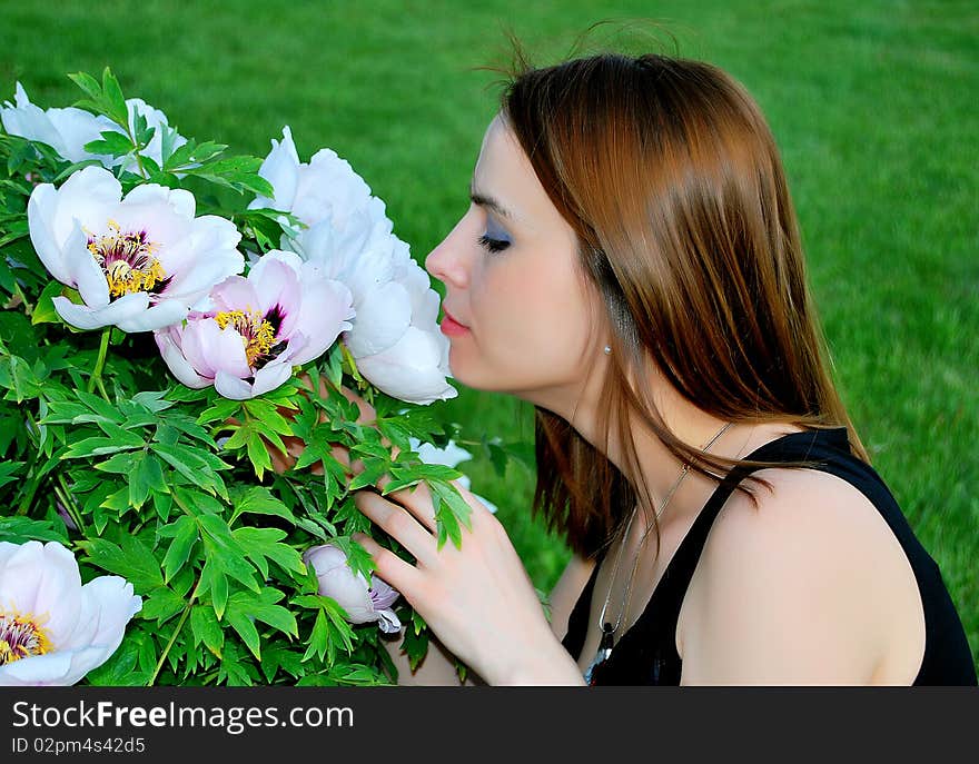 Girl is smelling flowers