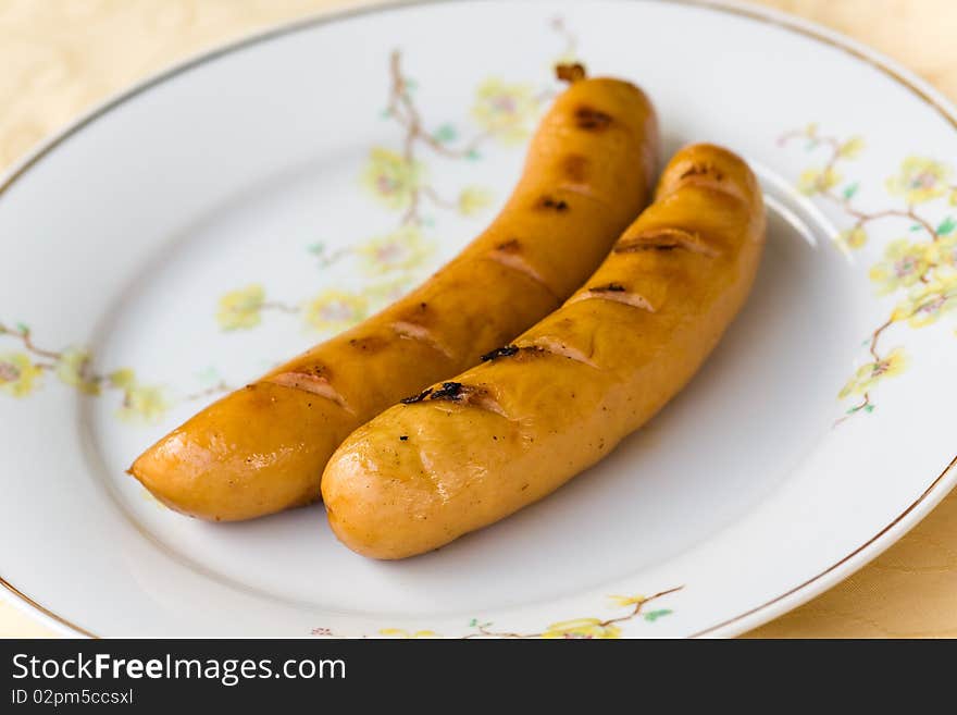 Two red sausages,grilled,close up . Two red sausages,grilled,close up .