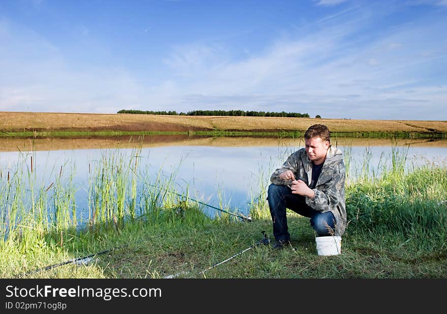 A fisherman collects a fishing-rod for fishing. A fisherman collects a fishing-rod for fishing