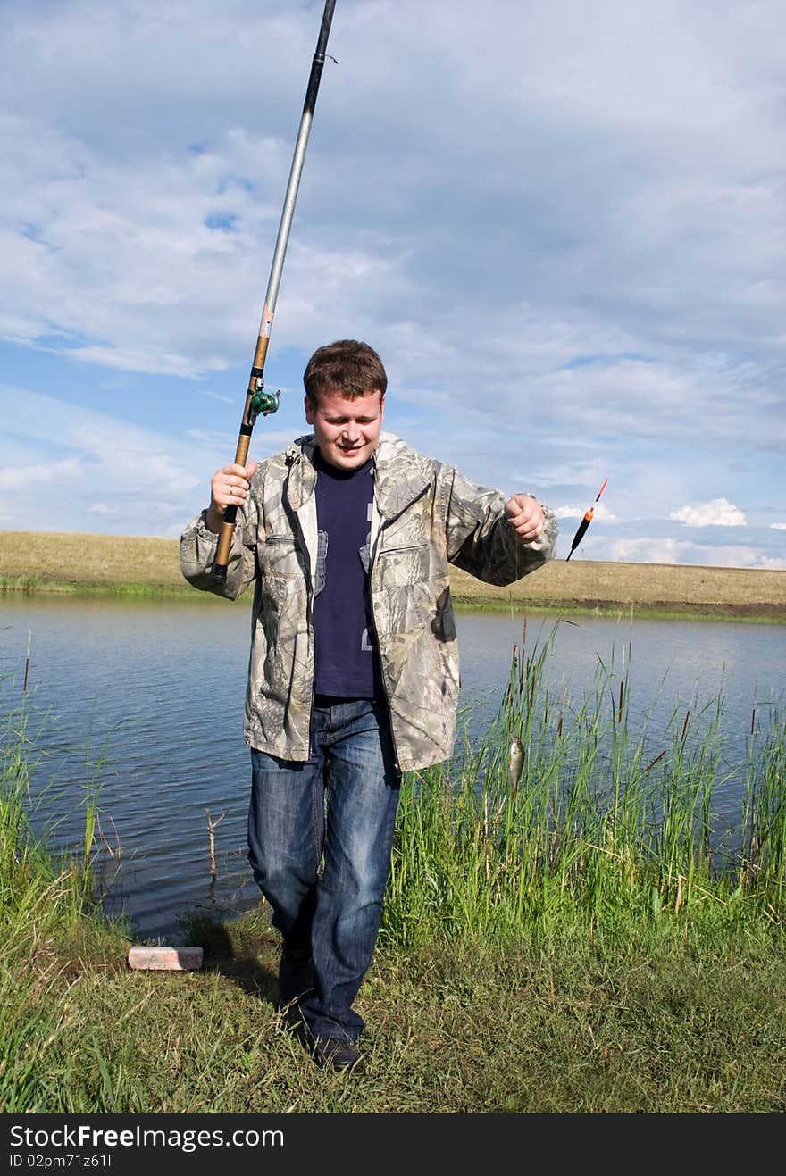 A fisherman collects a fishing-rod for fishing. A fisherman collects a fishing-rod for fishing