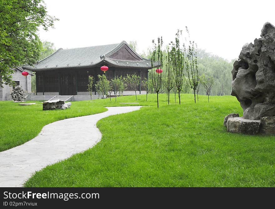 Garden With Green Meadow And Ancient Building