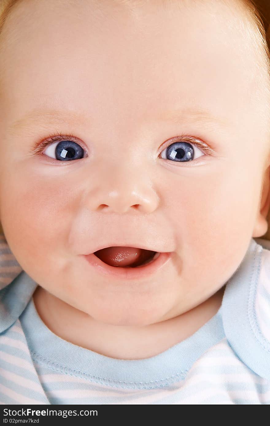 Portrait of happy smiling baby with blue eyes, studio shot. Portrait of happy smiling baby with blue eyes, studio shot