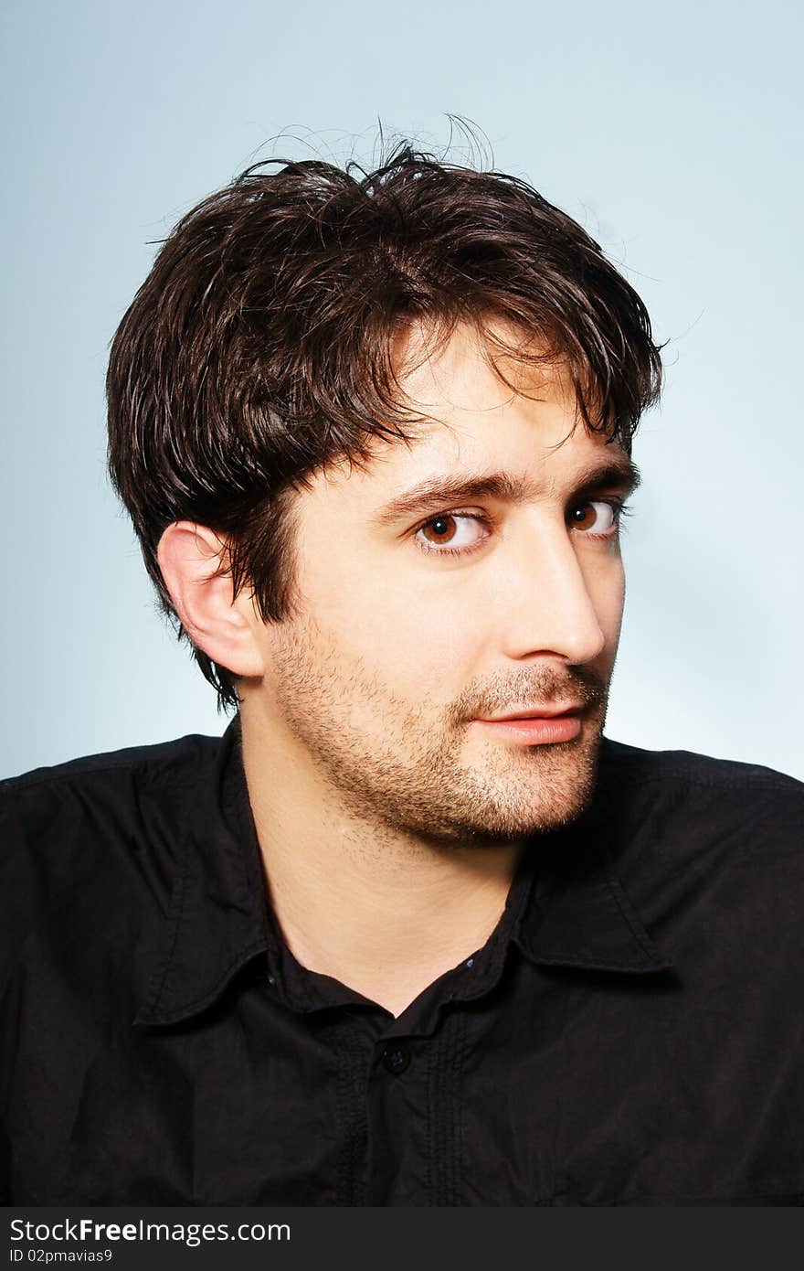 Portrait of young attractive dark-haired smiling man, studio shot. Portrait of young attractive dark-haired smiling man, studio shot