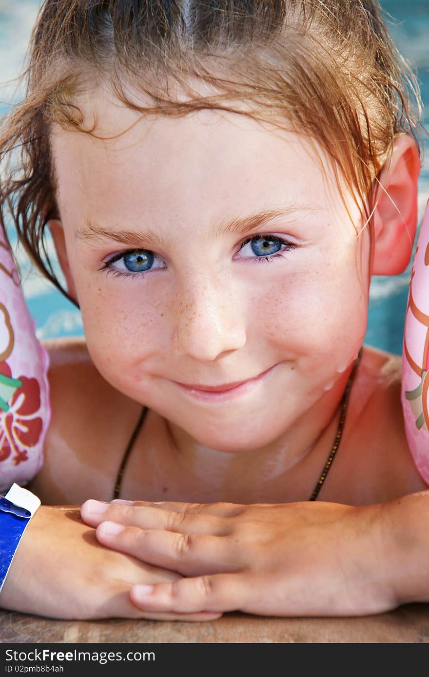 Portrait of pretty smiling blue-eyed girl in pool. Portrait of pretty smiling blue-eyed girl in pool