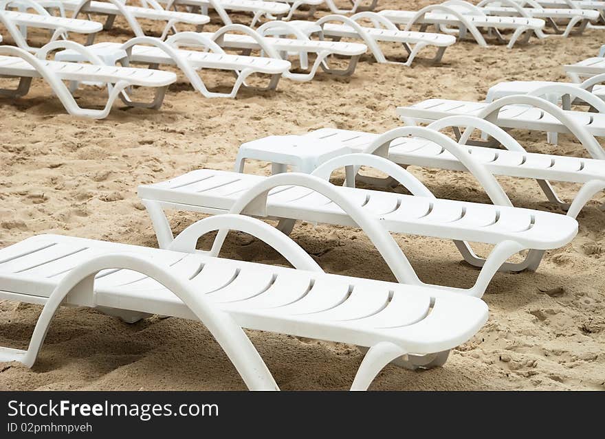 Area of a beach for comfortable rest with chaises longue