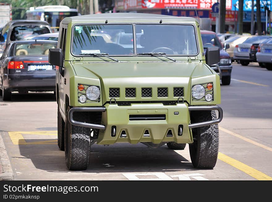 Military jeep stopped on the roadside in the downtown area. Military jeep stopped on the roadside in the downtown area