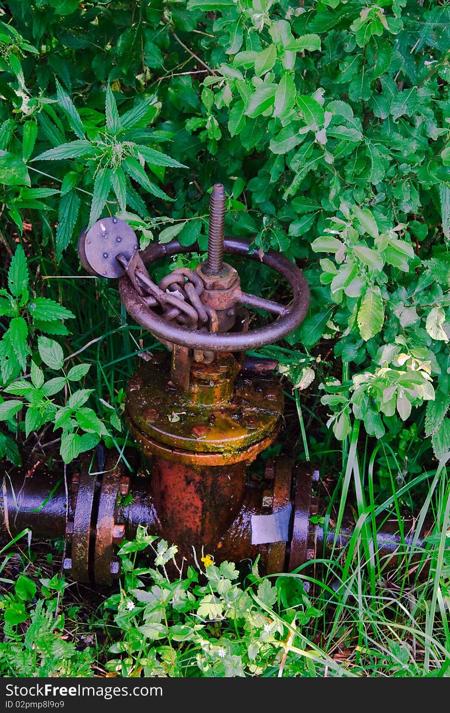 Old leaked  rusty country water supply system with chain and lock. Old leaked  rusty country water supply system with chain and lock