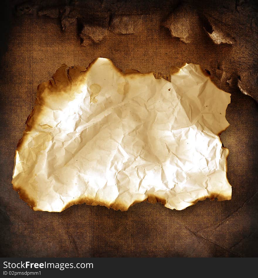 Vintage background with old burnt crumpled paper. Vintage background with old burnt crumpled paper