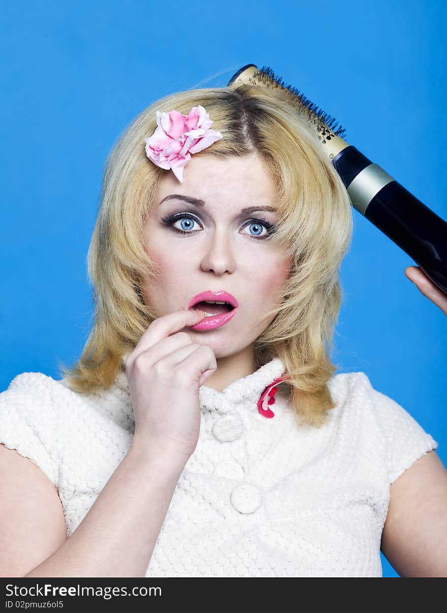 Young blond woman with broken hairdryer