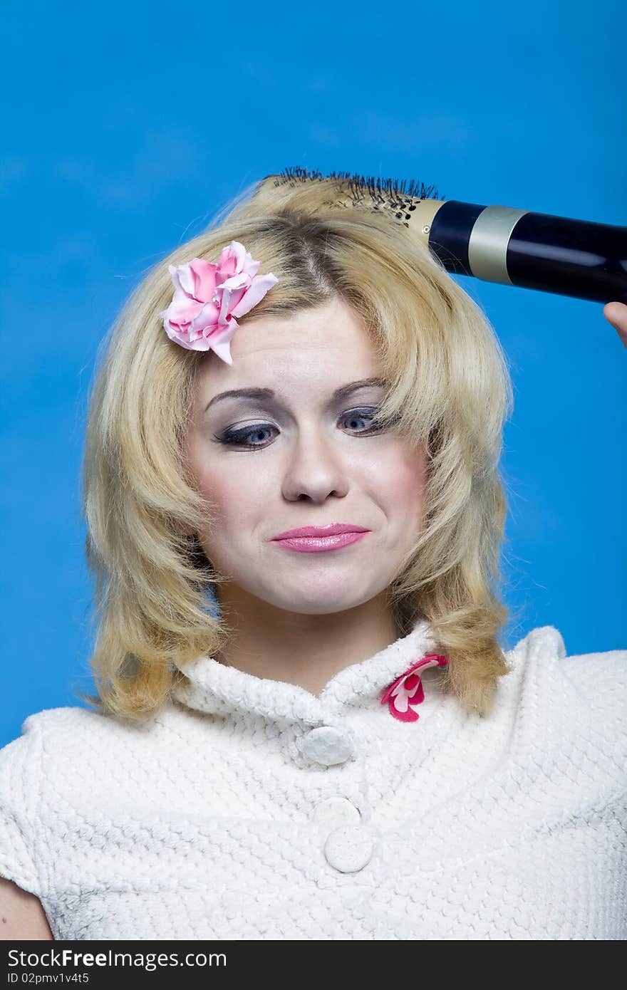 Funny blond with hairdryer