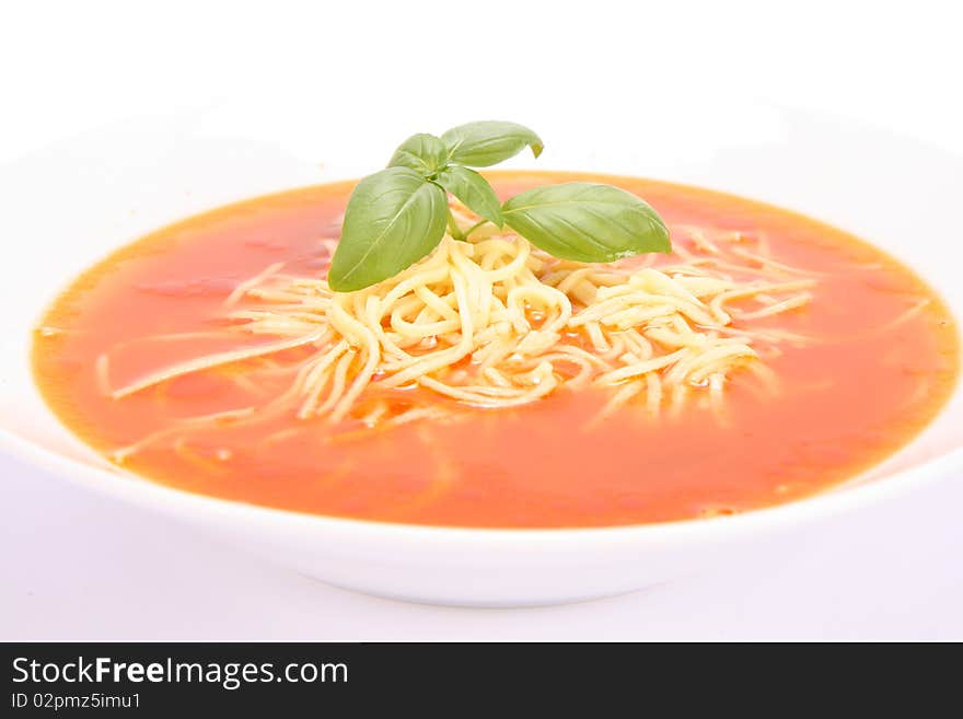 Tomato soup with macaroni decorated with basil