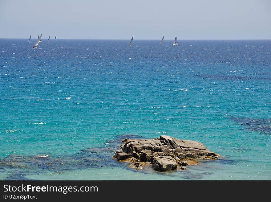 Race of sailboats in the beautiful sea of Sa Ruxi, Villasimius, in Sardinia, Italy. Race of sailboats in the beautiful sea of Sa Ruxi, Villasimius, in Sardinia, Italy.