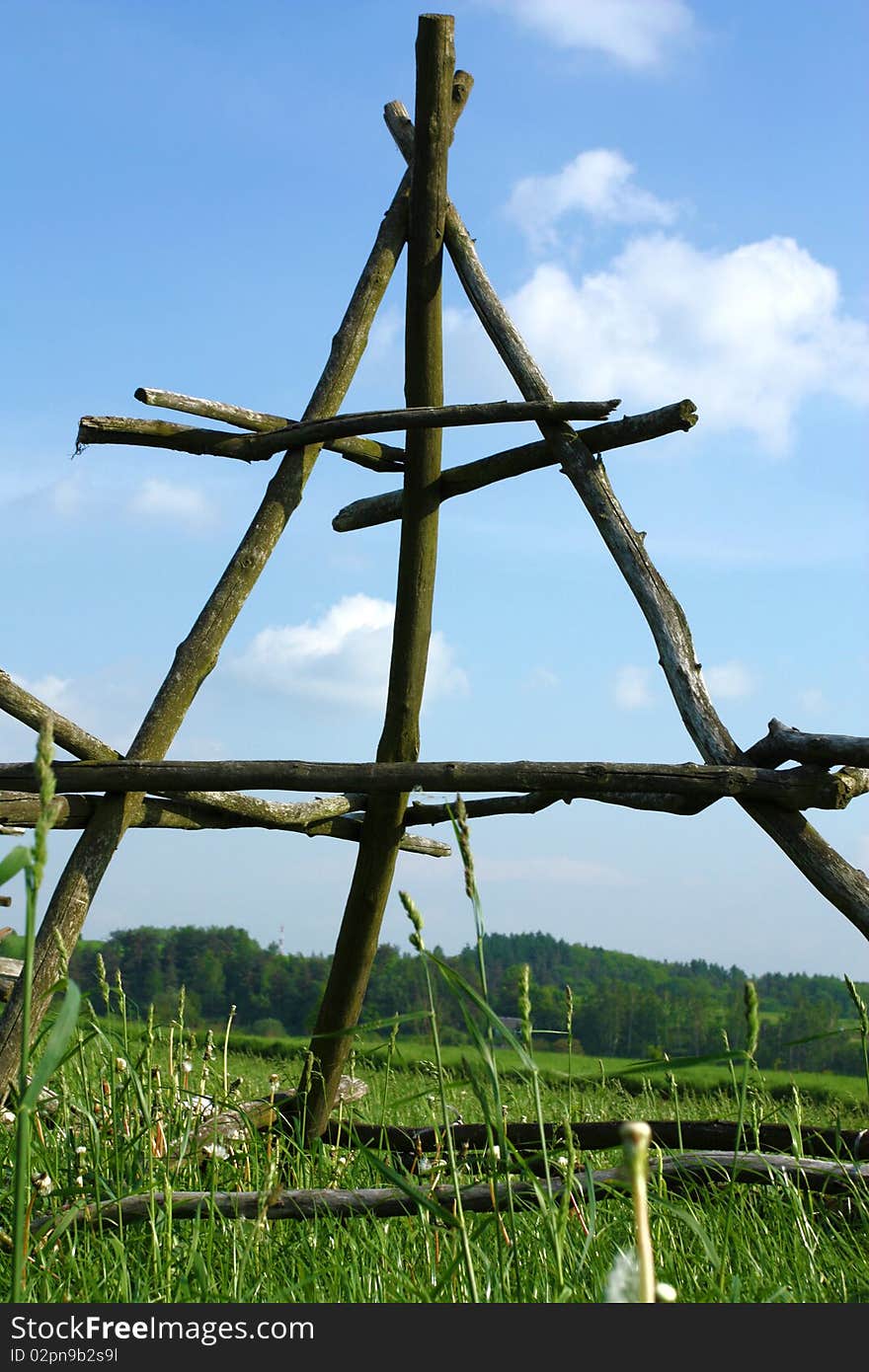 Rural landscape in Malopolska (Poland). Wooden construction for curing hay stacks