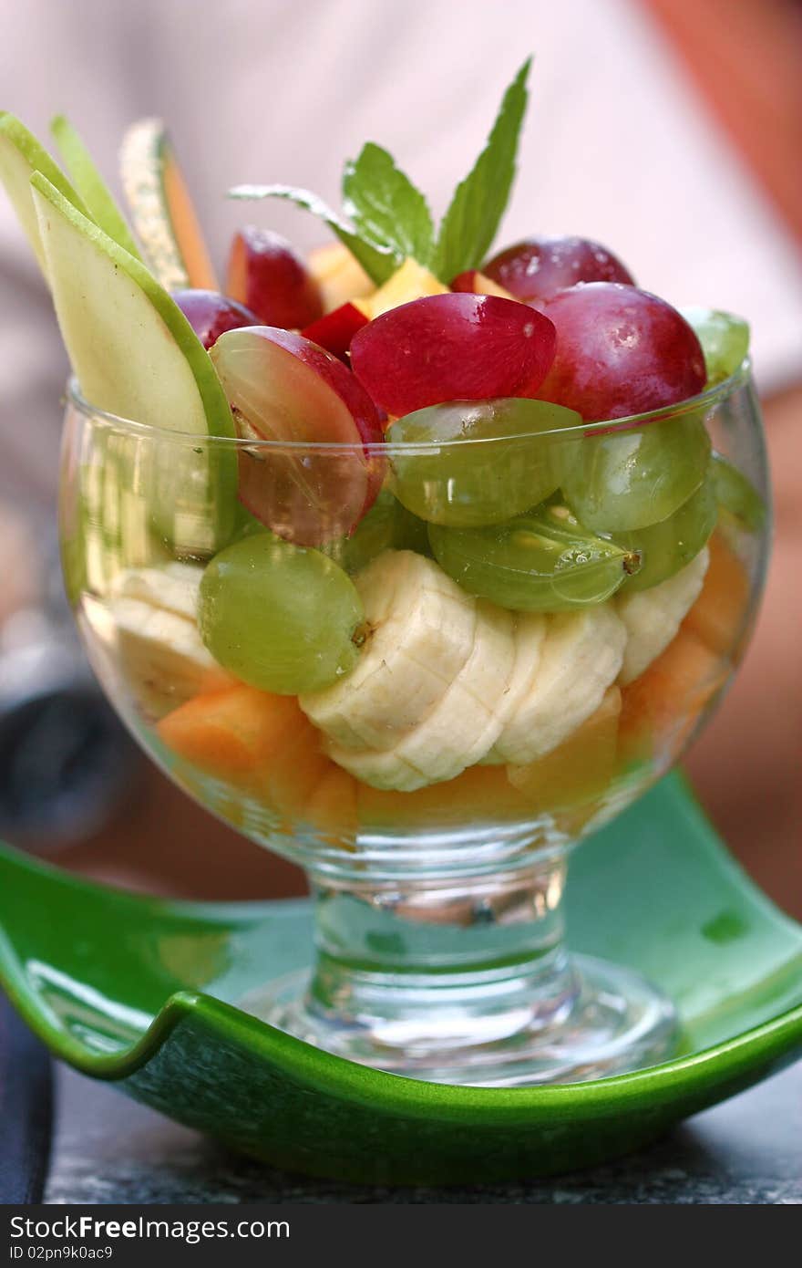 Mix of fruits in glass goblet. Summer dessert