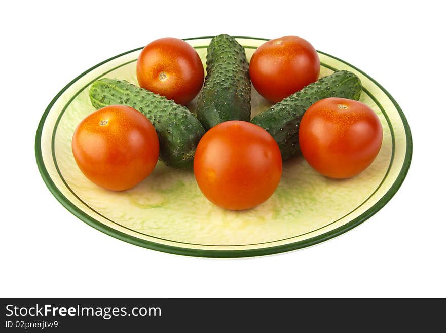 Fresh raw tomatoes and cucumbers on a plate. Fresh raw tomatoes and cucumbers on a plate