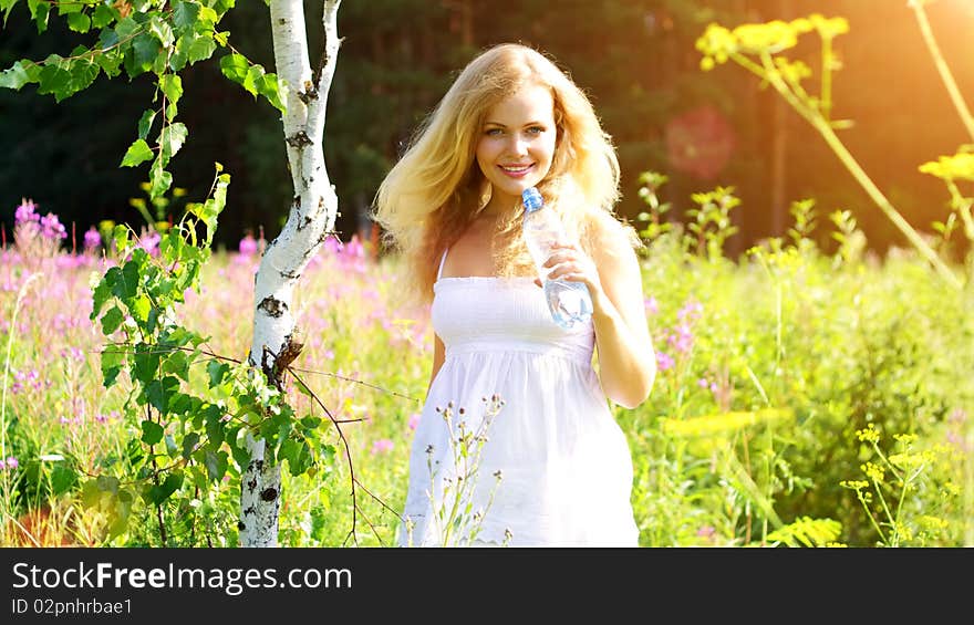 Beautiful girl holding a bottle of water