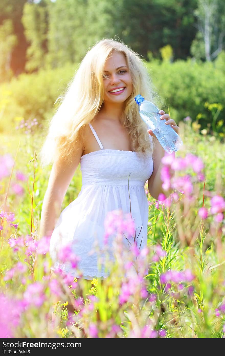 Beautiful girl holding a bottle of water