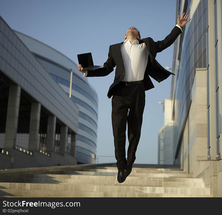 Jumping businessman over urban background. Jumping businessman over urban background