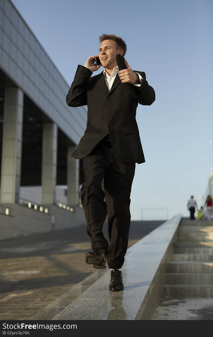 Young businessman calling on mobile phone, outdoor. Young businessman calling on mobile phone, outdoor.