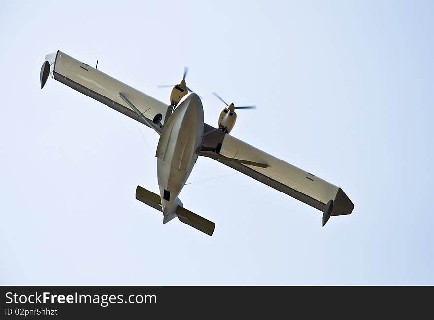 Hydro plane in the air. Against the background of blue sky. Photo was taken from the bottom. Close-up fuselage.