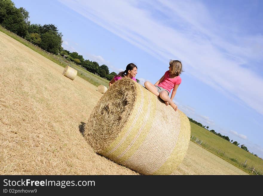 White people having fun on hay bales