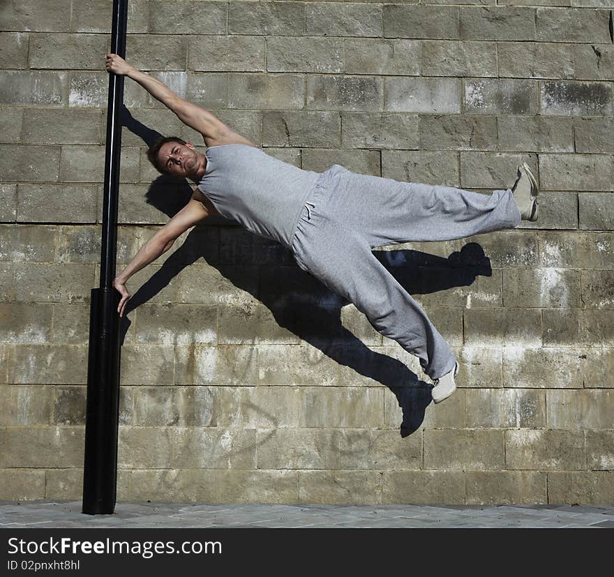 Young attractive man dancing in urban background. Young attractive man dancing in urban background