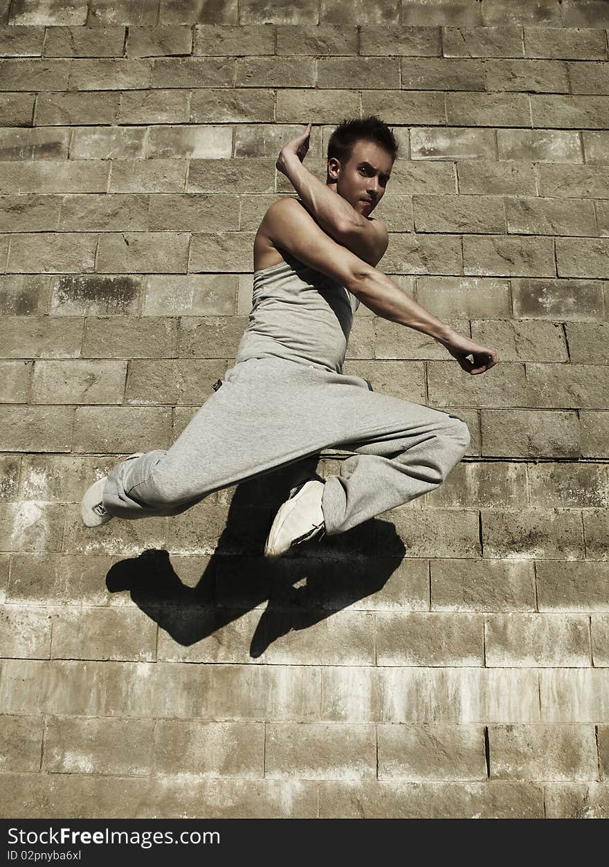 Young attractive man dancing in urban background. Young attractive man dancing in urban background