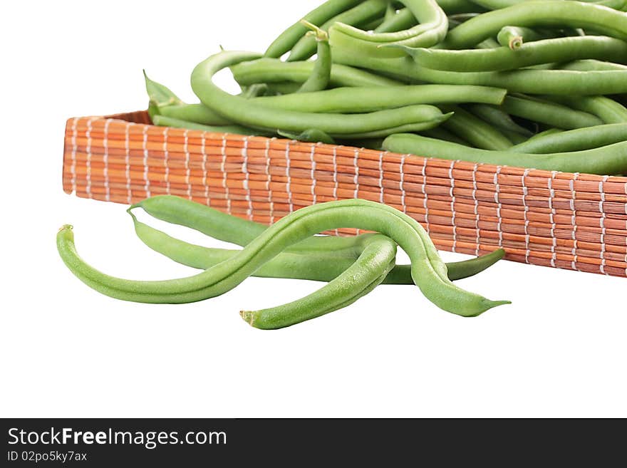 Young green French string bean in pods on a white background. Young green French string bean in pods on a white background.