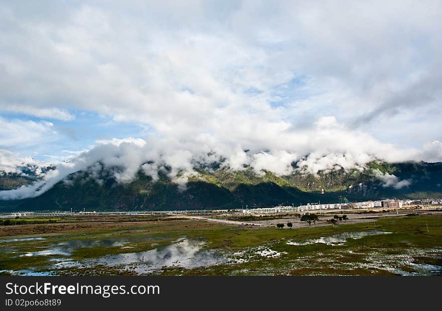 Mountain landscape with green trees covered and white cloudscape