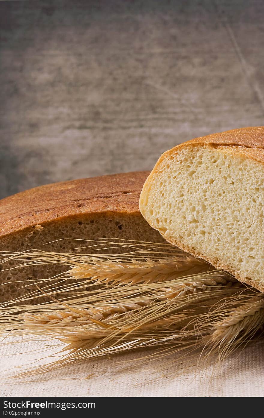 Wall and tasty bread on table