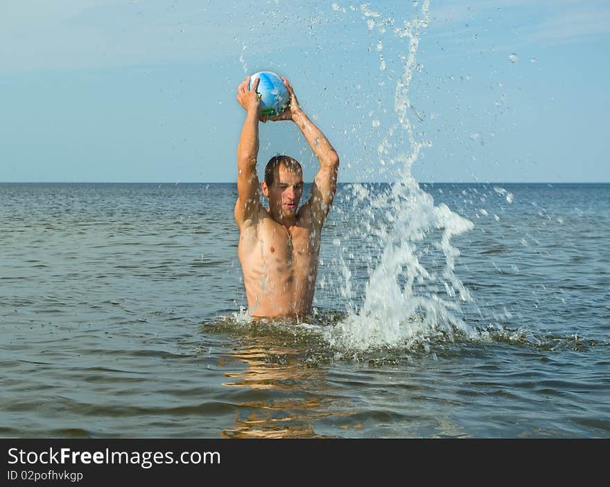 Man play with ball in the water. Man play with ball in the water.