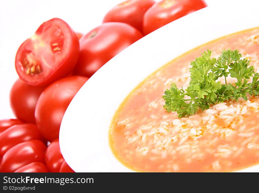 Tomato soup with rice decorated with parsley with fresh tomatoes