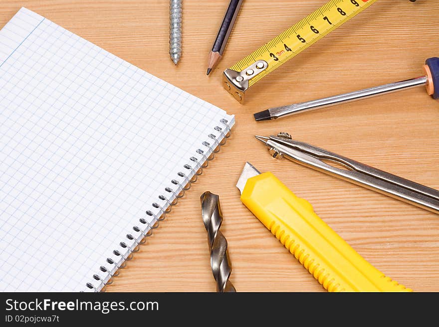 Note pad and tools on table