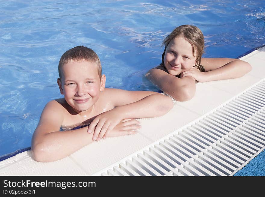 Girl and boy in swimming pool. Girl and boy in swimming pool