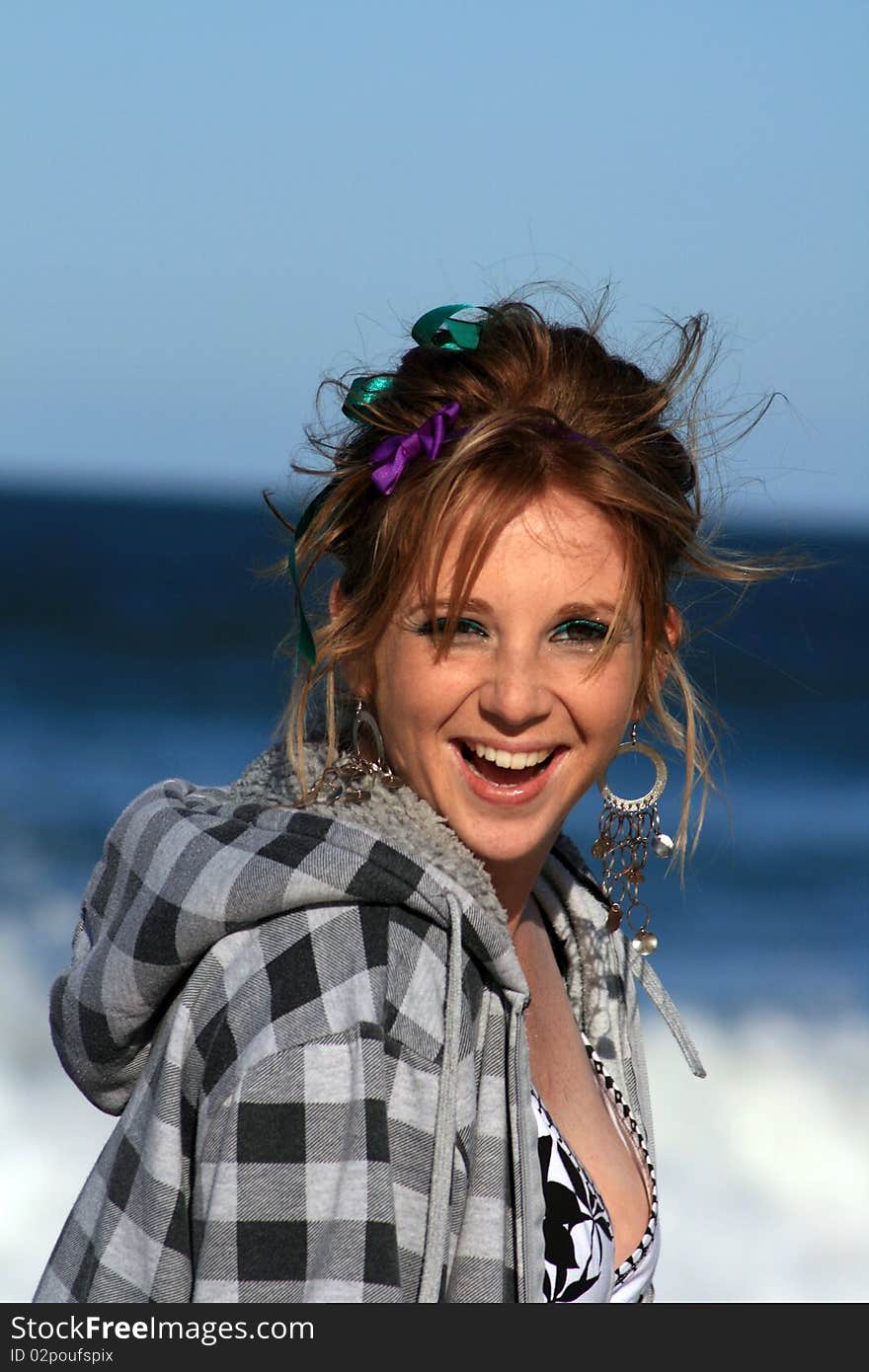 A beautiful white caucasian girl teenager with a happy expression on her face enjoying the beach. A beautiful white caucasian girl teenager with a happy expression on her face enjoying the beach