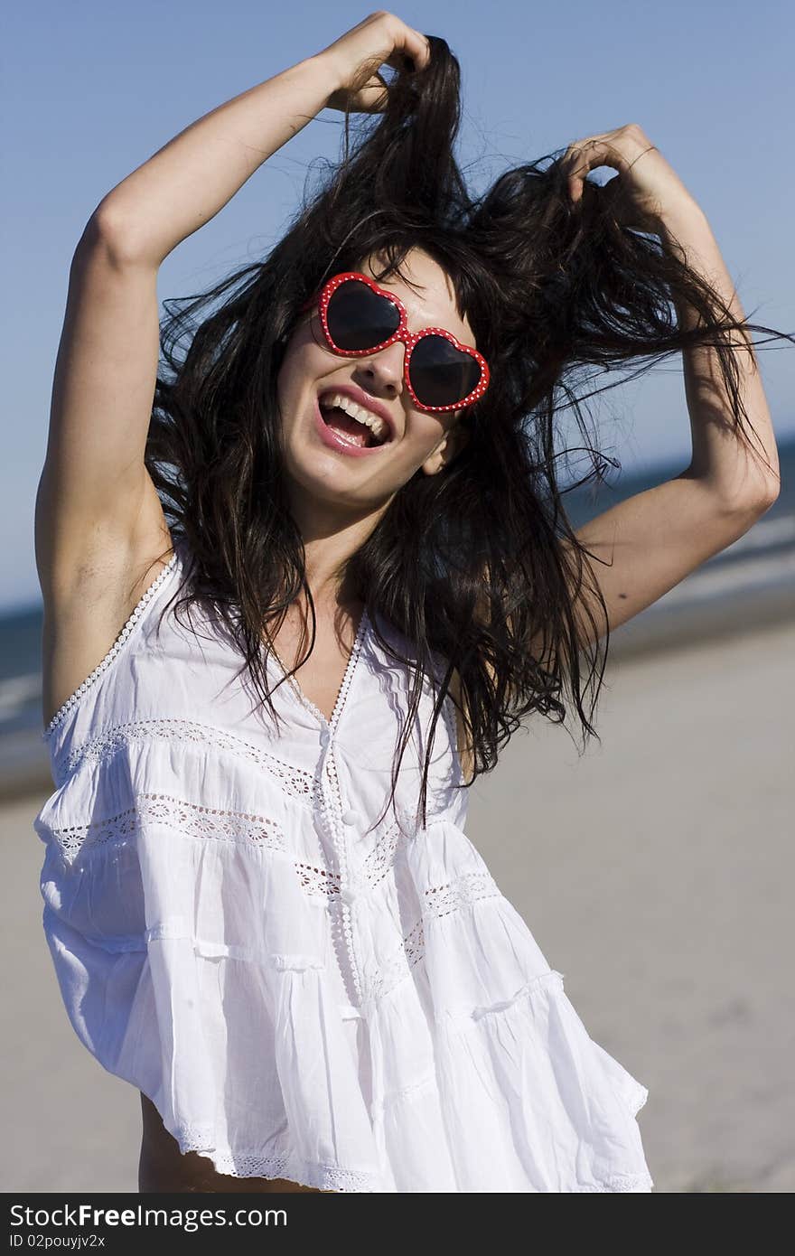 Portrait of happy young woman with stylish sunglasses playing with her hair. Portrait of happy young woman with stylish sunglasses playing with her hair