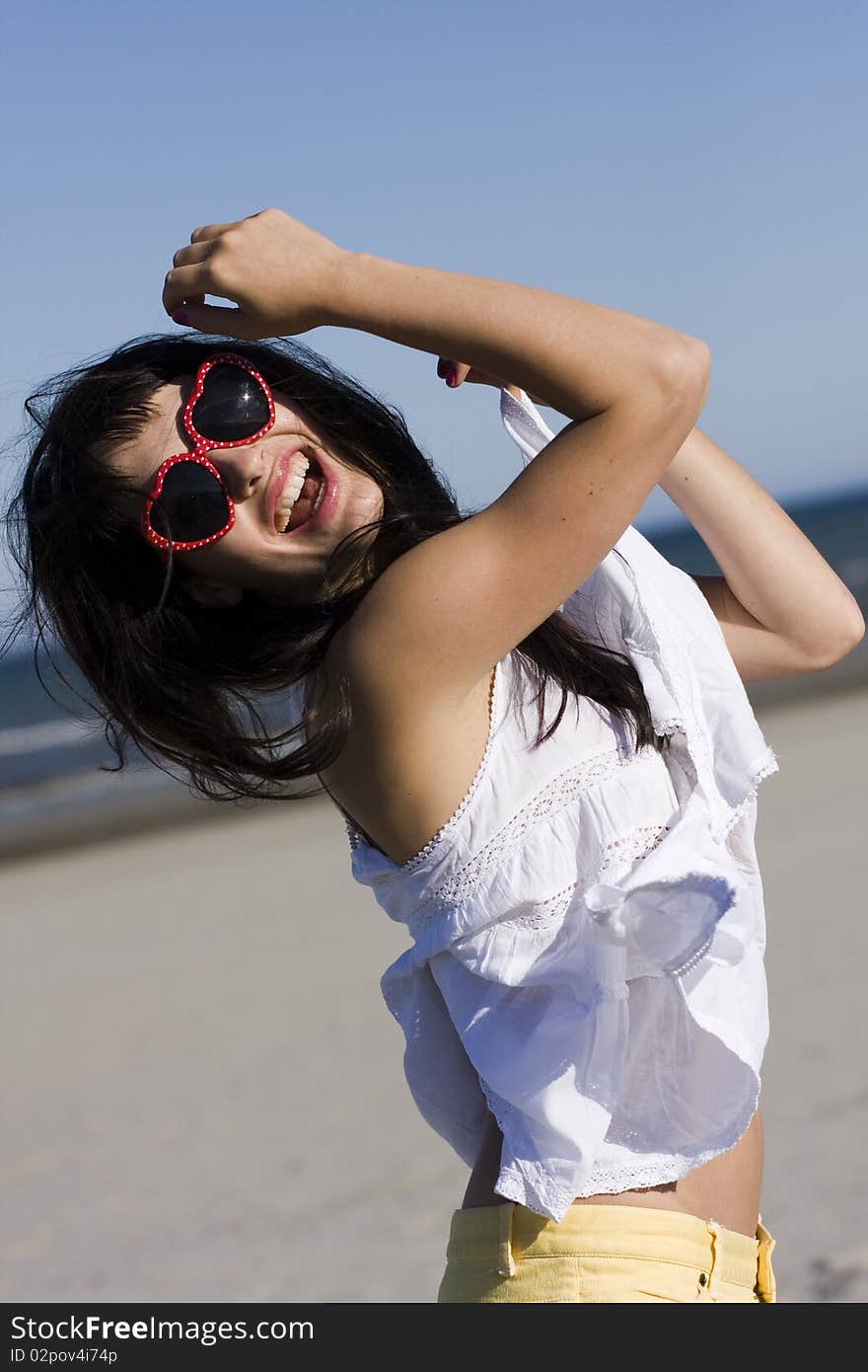 Portrait of happy young woman with stylish sunglasses playing with her hair. Portrait of happy young woman with stylish sunglasses playing with her hair