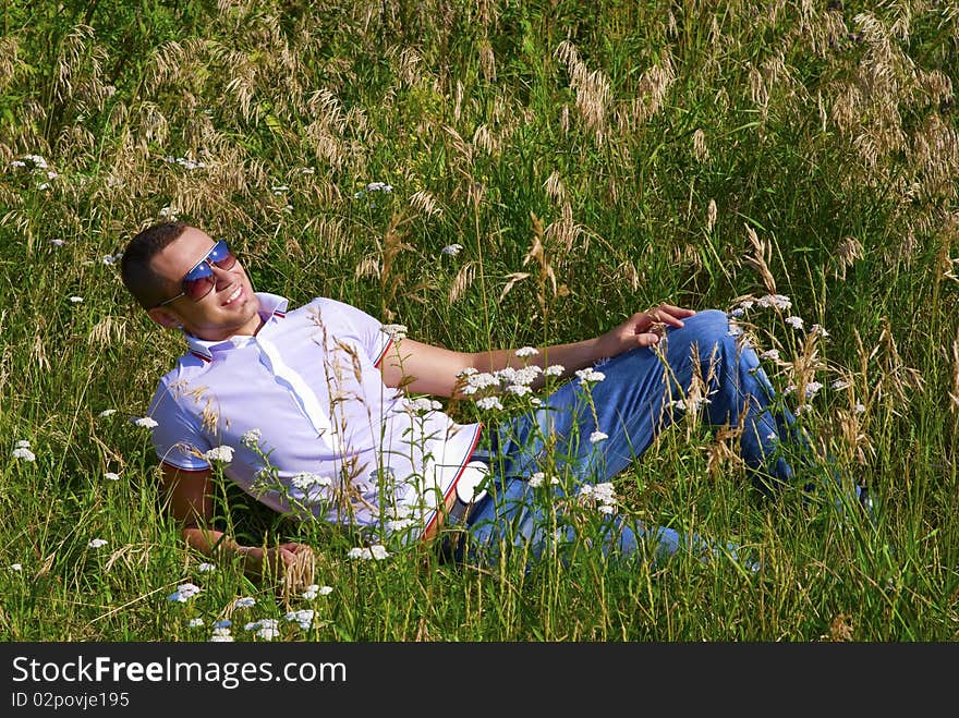 Happy Young Man In Grass