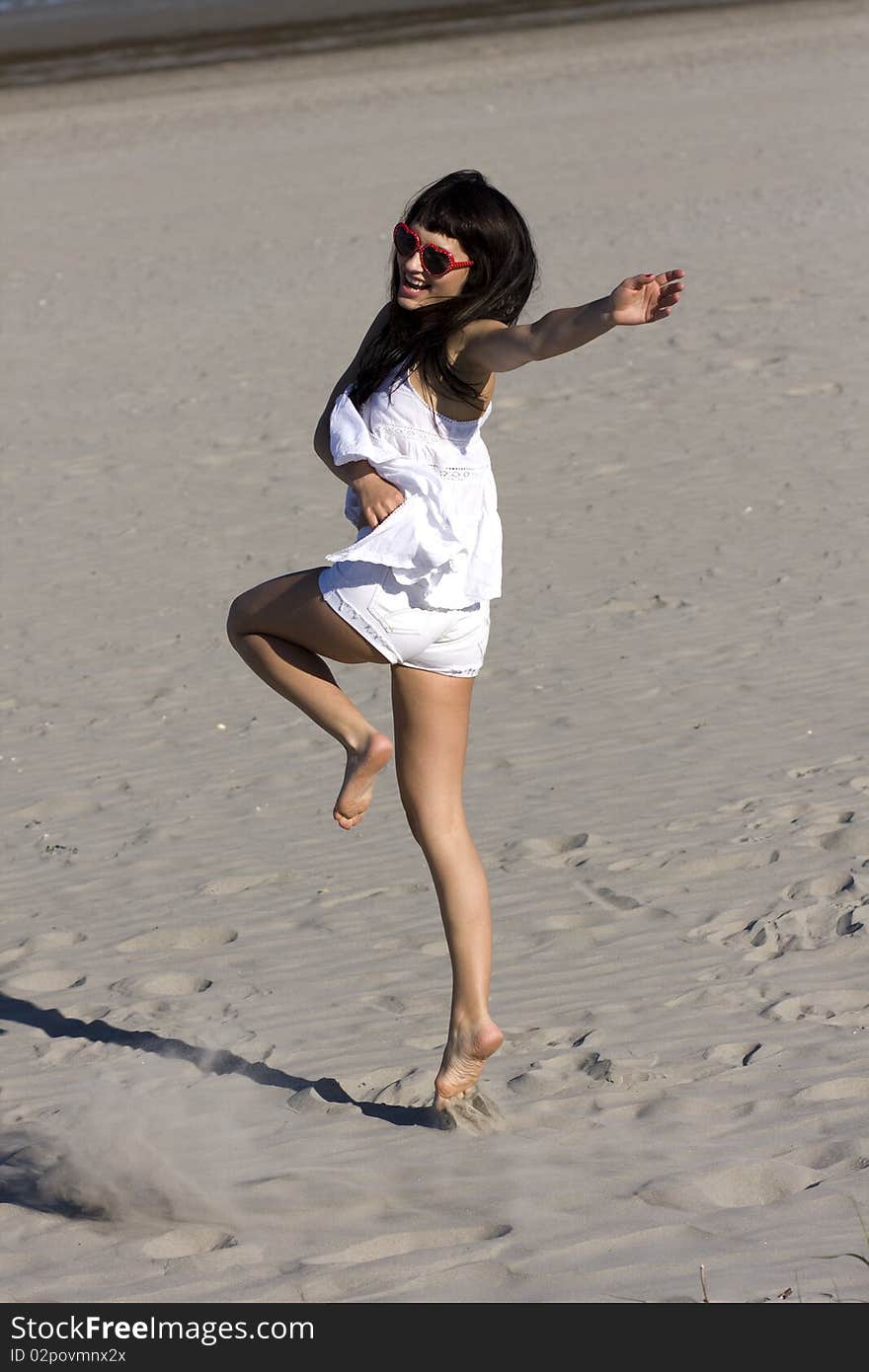 Happy young atractive woman is exercing on the beach. Happy young atractive woman is exercing on the beach