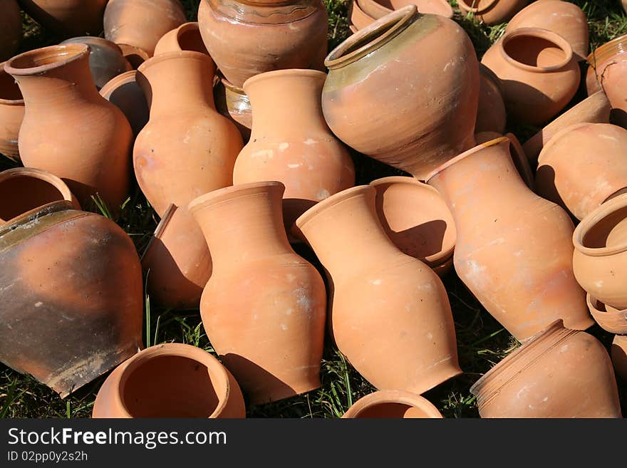 Traditional ukrainian clay pots lying on the grass