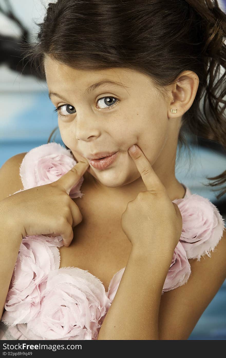 Girl making funny face with smile and dimples