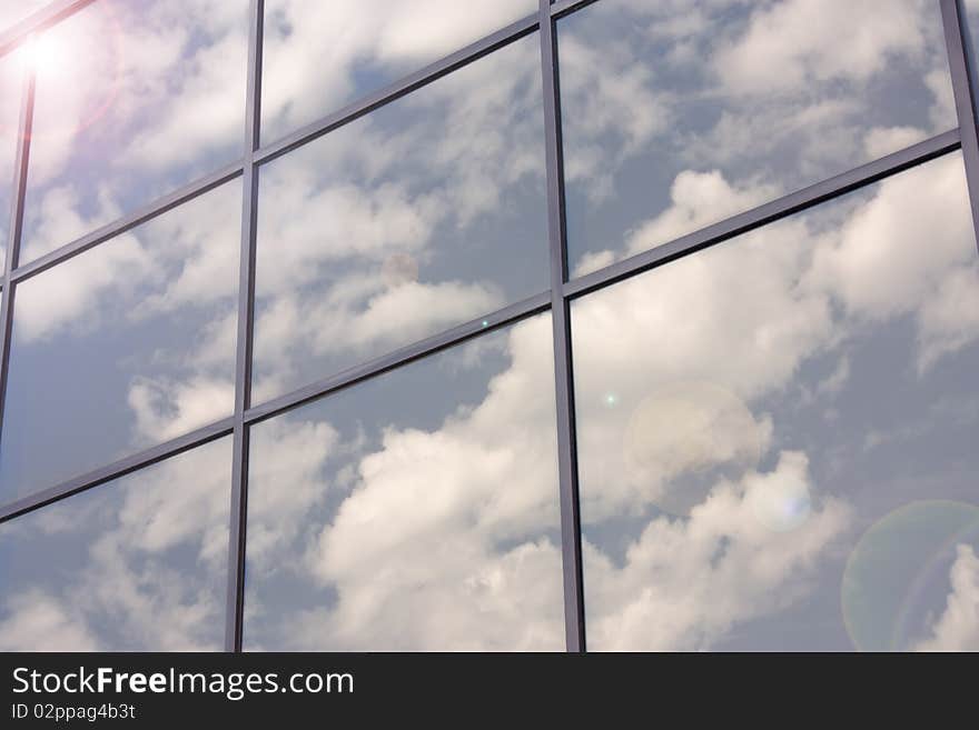 Reflection of blue sky with clouds in the glass surface. Reflection of blue sky with clouds in the glass surface