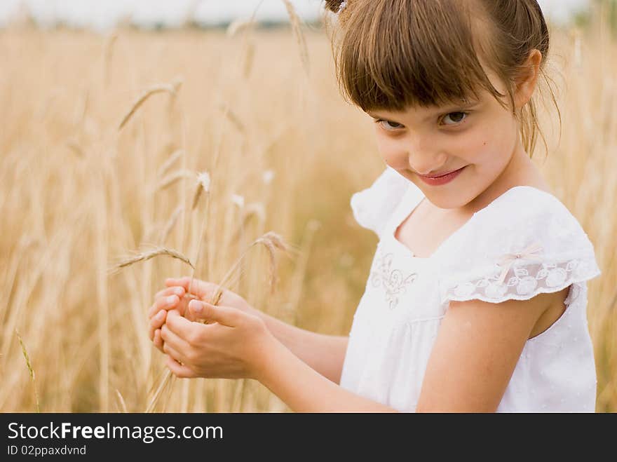 Girl on field holding spikes in hands made out. Girl on field holding spikes in hands made out