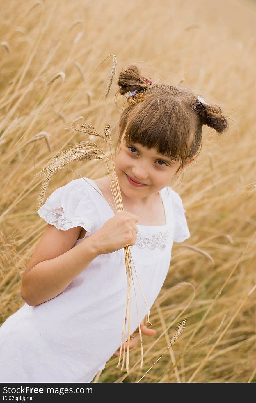 Girl on field holding spikes in hands made out. Girl on field holding spikes in hands made out