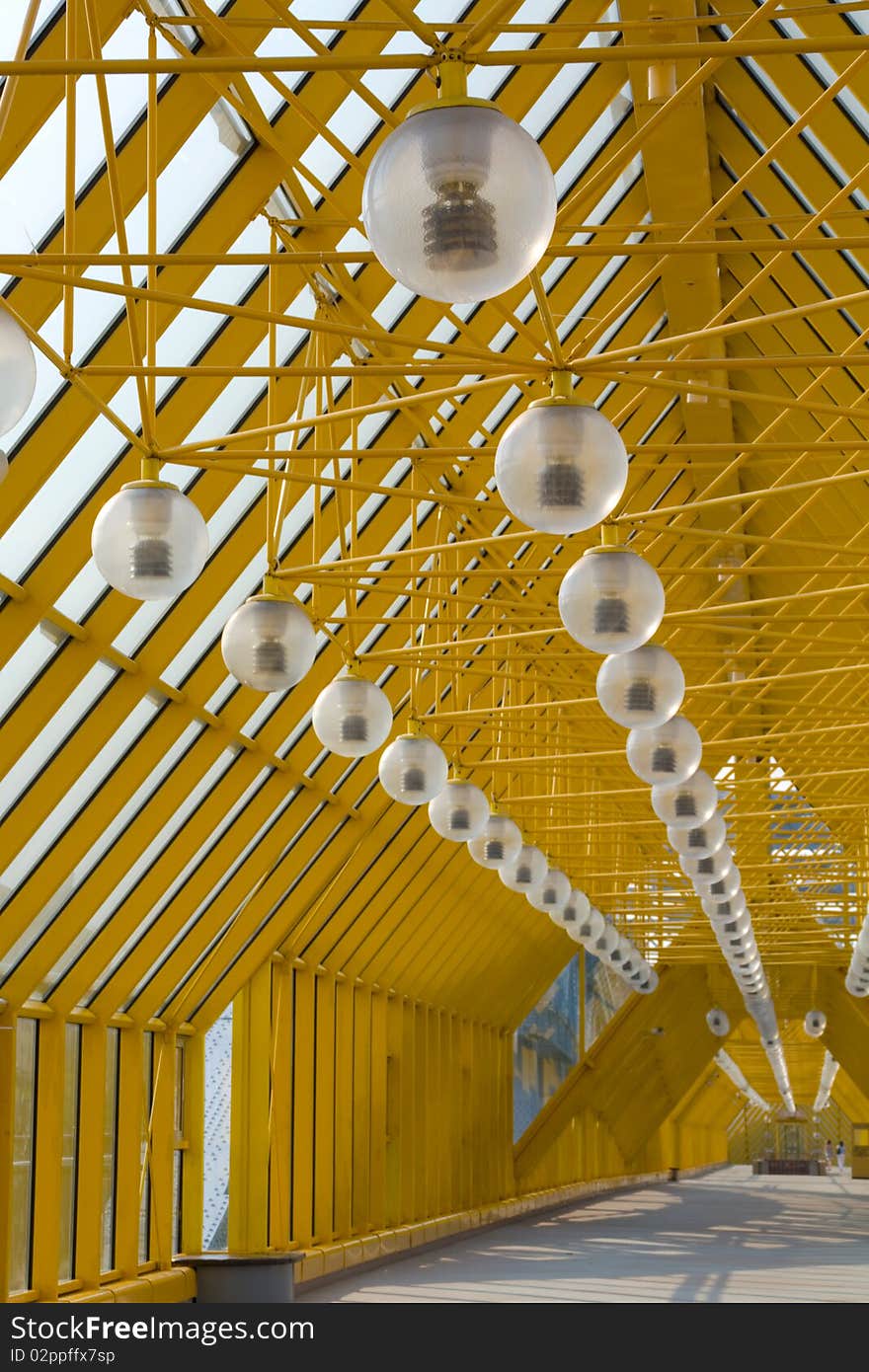 Transparent glass roof, with fixtures suspended inside.