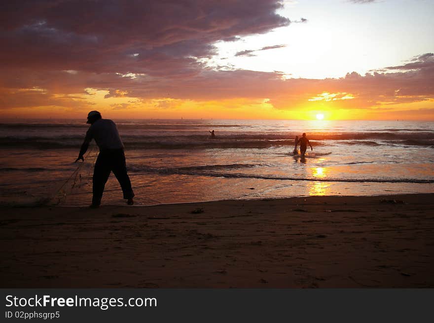 Fishermen bringing in the catch of the day. Fishermen bringing in the catch of the day.