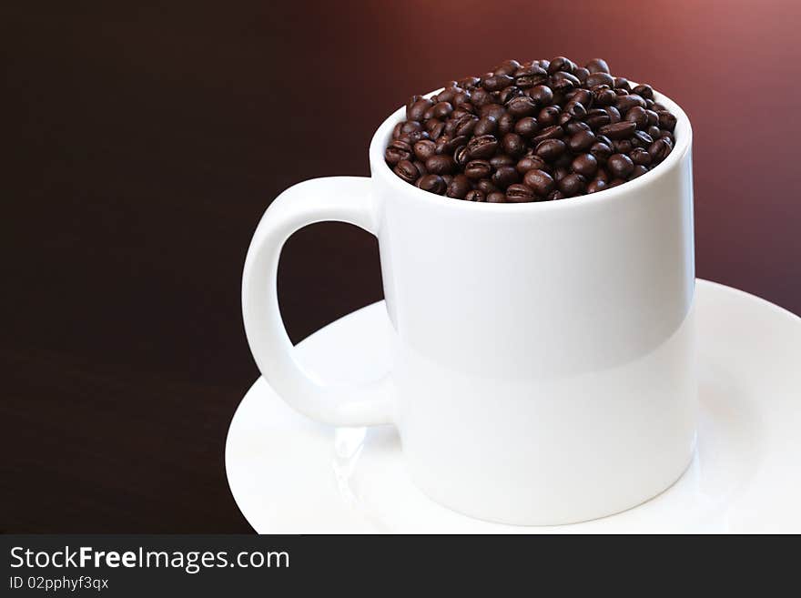 Coffee mug filled with fresh coffee beans